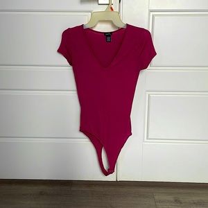 X Small deep v tshirt one piece. In color pink.